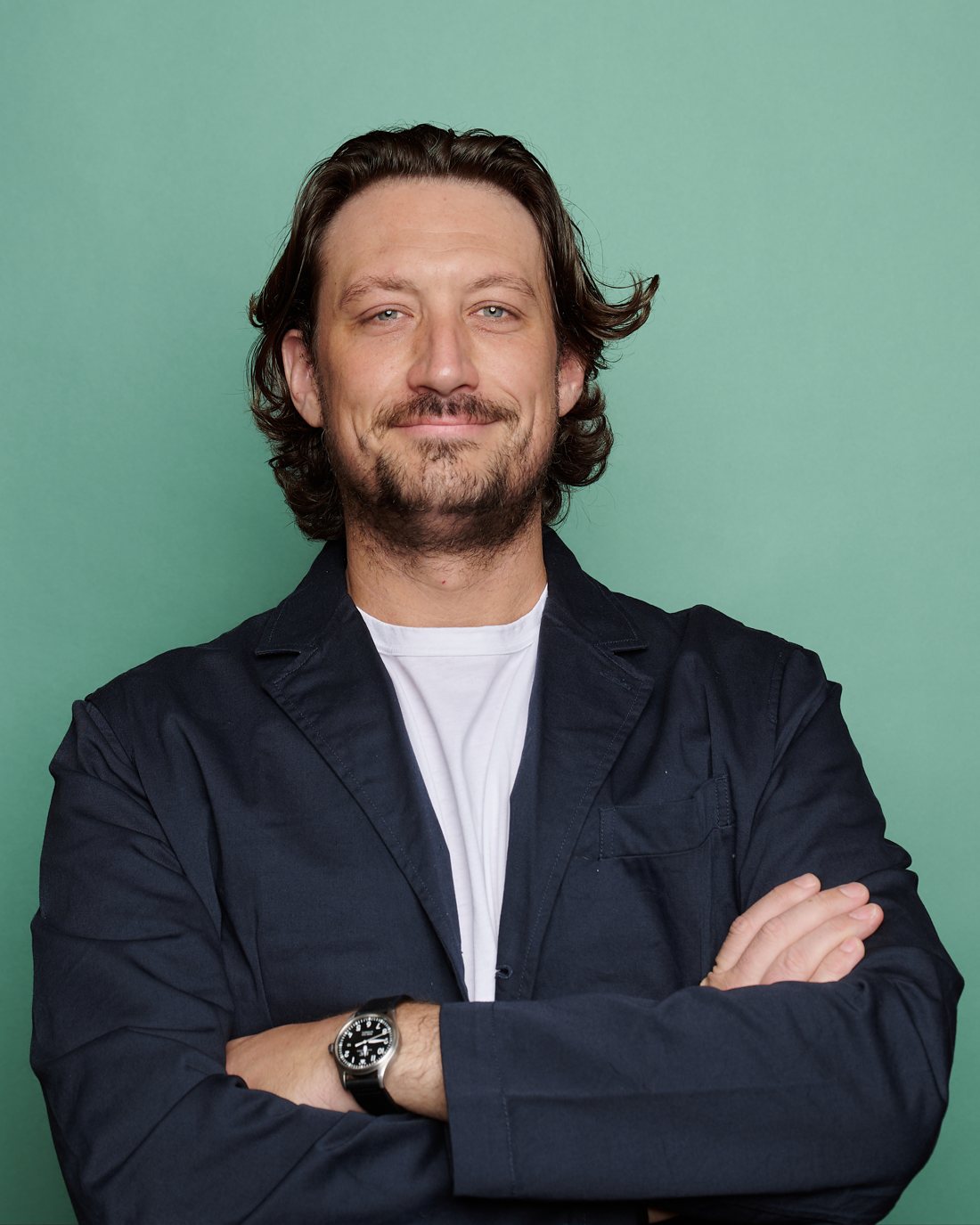 Tobias Dawes, founder of Agentflowz, standing with arms folded